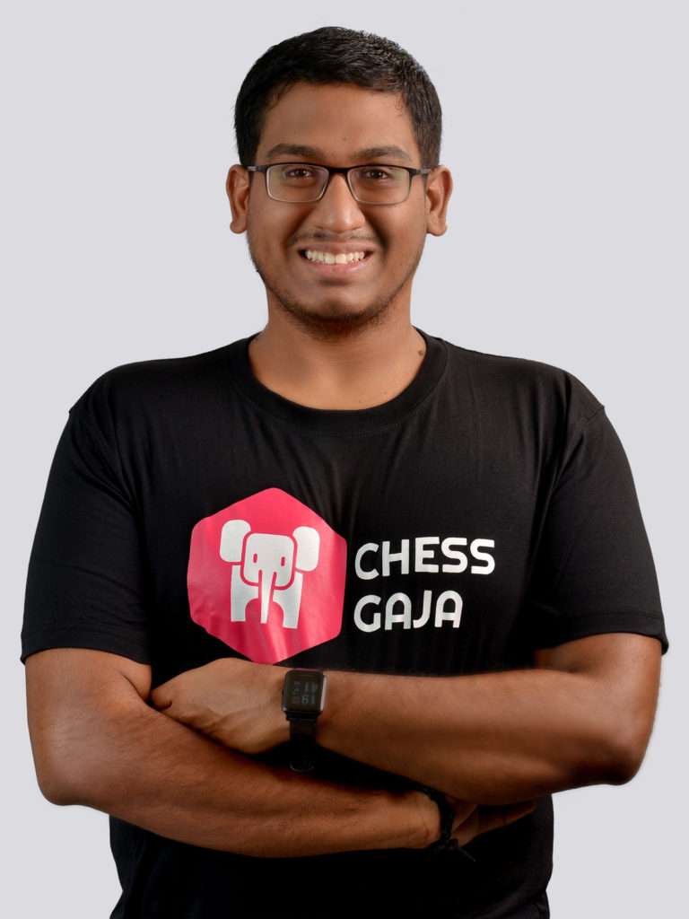 A man wearing a black t-shirt with the words "chess openings gaia" on it.