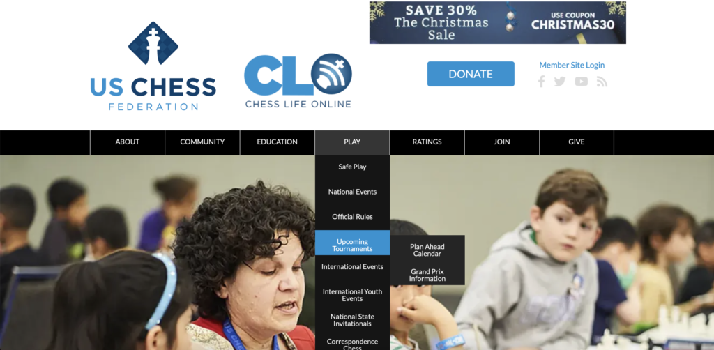 Screenshot of the US Chess Federation website homepage showing menu options and a banner ad for a Christmas sale.