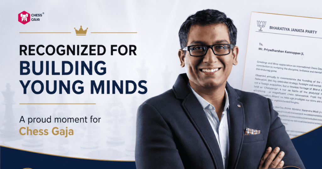 A man in a suit smiles in front of a certificate with the text “Recognized for Building Young Minds. A proud moment for Chess Gaja” displayed beside him.