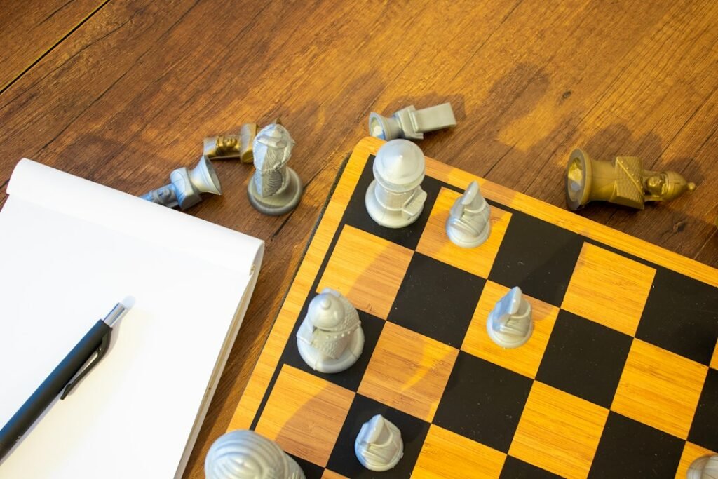 Chess board with pieces mid-game next to a blank notepad and pen, representing game analysis and annotation for improving chess at the 1200 level.