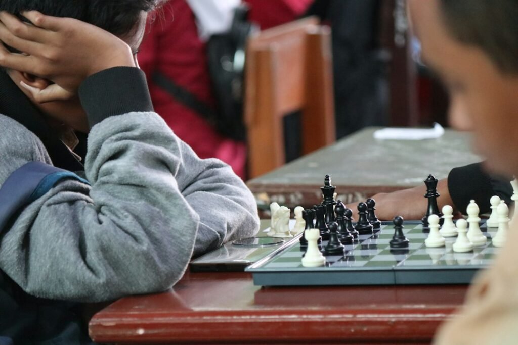 Young players competing at a chess tournament board, focused on the game